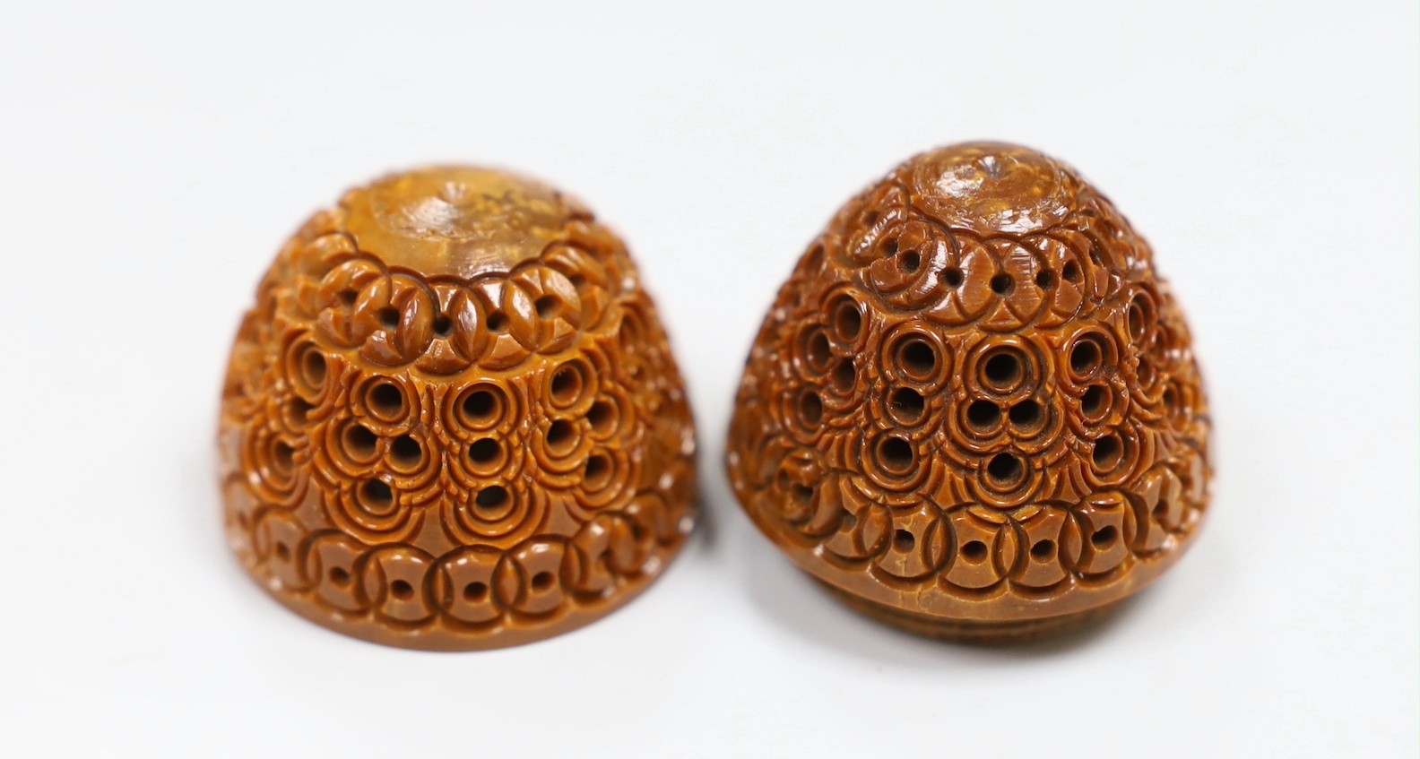 Five Chinese peach stone carvings, largest 4.2cm and a coquilla nut egg shaped box